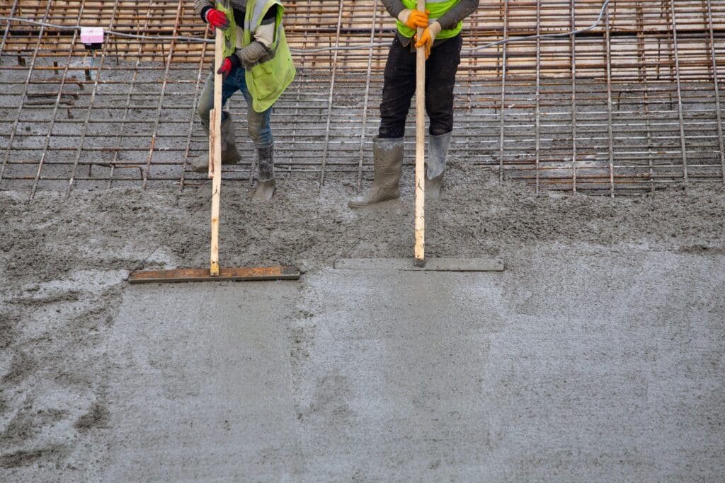 Solid State Concrete experts leveling a fresh concrete slab in Fargo, ND.